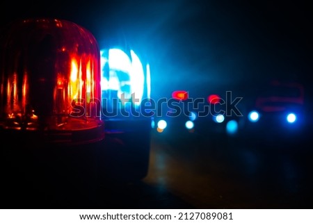 Police car blue and red round vintage siren in dark. Rotating retro style police siren. Selective focus Royalty-Free Stock Photo #2127089081