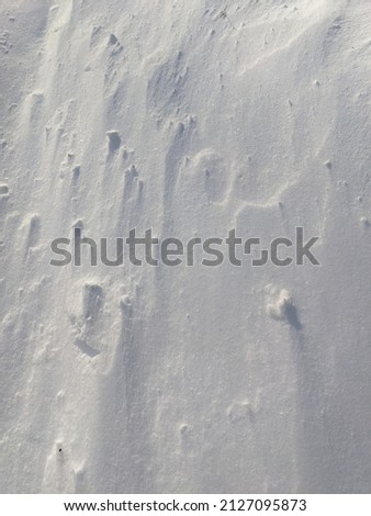 Snow surface, snow wall on windy day