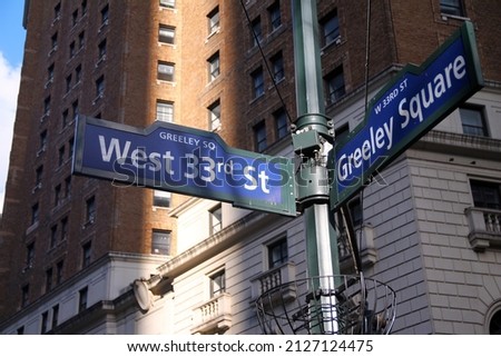 Blue West 33rd Street and Greeley Square on Broadway historic sign in Midtown Manhattan in New York City