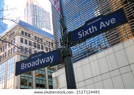 Blue Sixth Avenue and Broadway historic sign in Midtown Manhattan in New York City