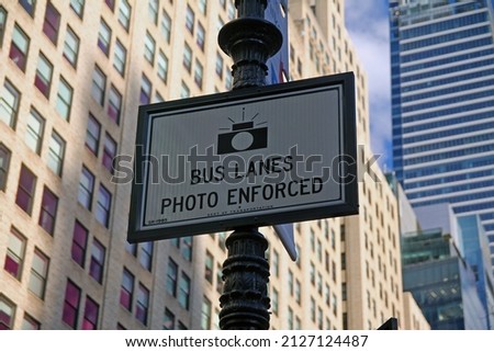 White Bus Lanes Photo Enforced sign hanging on a black pool in downtown Manhattan in New York City