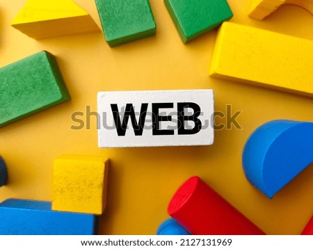 Top view colored wooden block with text WEB on a yellow background.