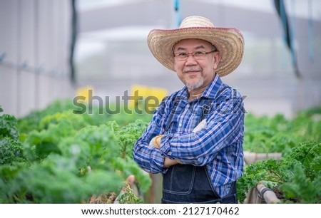 Portrait Asian farmers pose checking fresh organic vegetable in hydroponic smart farm, produce agriculture with business, healthy clean food concept.