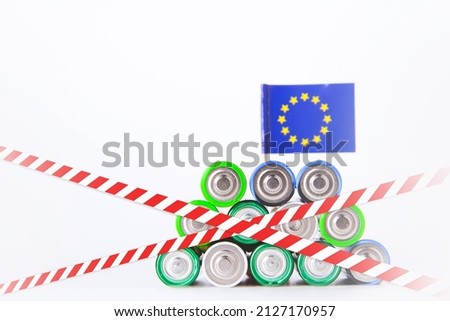 Battery ban in the European Union. Batteries are enclosed with red and white tape. Disposal of waste from batteries. Dump of electronic waste.