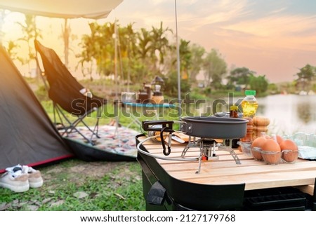 Good morning. Cooking food during camping at natural park in Thailand. Recreation and journey outdoor activity lifestyle. Royalty-Free Stock Photo #2127179768
