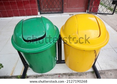 Trash bag, yellow bins for non-organic and green for recyclable organic waste