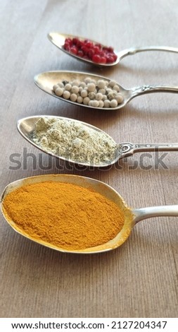 Antique spoons with spices. Nutmeg, pepper, turmeric. Cutlery. High quality photo