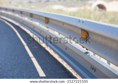 Guardrails poles covered crash-absorber beam. Shoulder view. Motorists safety concept Royalty-Free Stock Photo #2127221105