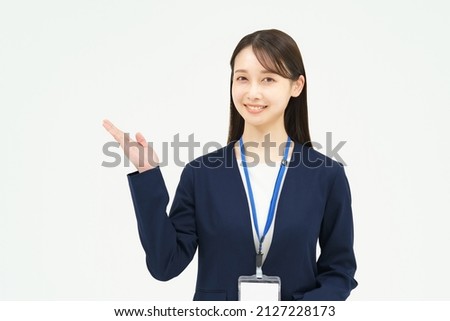 A woman in a suit posing as a guide Royalty-Free Stock Photo #2127228173