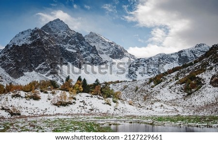 travel to Caucasus mountains in Karachay-Cherkessia, Arkhyz. Beautiful mountain landscape. Lake Orlyonok with Mount Karadzhash, autumn season
