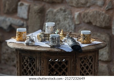 Close-up Turkish tea set with small cups and metal decorations