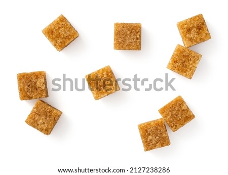 Brown sugar cubes isolated on white background, top view Royalty-Free Stock Photo #2127238286