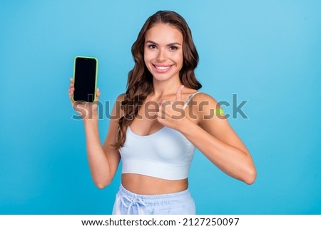 Photo of attractive style brunette lady did vaccination promote telephone thumb up wear teal top isolated on blue color background
