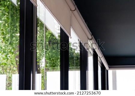 
Roller Blinds or curtains at the glass wall