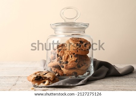 Glass jar with tasty homemade cookies on table Royalty-Free Stock Photo #2127275126