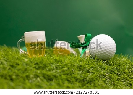 Golf ball for St. Patrick's Day on green grass. St. Patrick's Day is celebrated annually on March 17, the anniversary of his death in the fifth century. The Irish have observed this day as a religious
