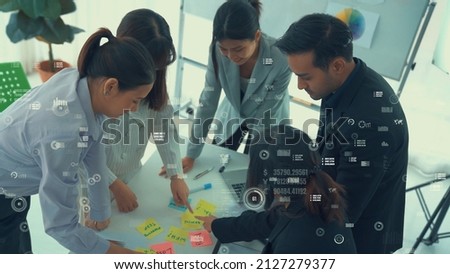 Business people in corporate staff meeting with envisional graphic . Concept of digital technology for marketing data analysis and investment decision making .