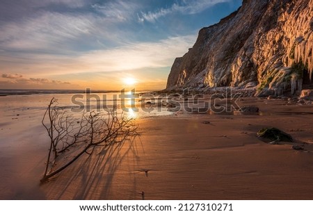 Sunrise on a sandy beach. Beautiful sunrise over beach. Sandy beach at dawn. Sunrise beach landscape Royalty-Free Stock Photo #2127310271