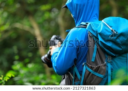 Woman photographer taking photo  in spring forest