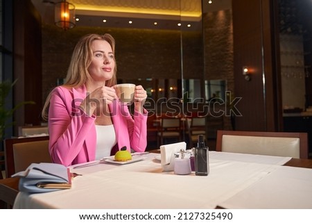 Successfyl lady having dellicous coffee at fancy cafe