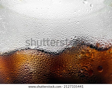 Macro photo of cold water droplets side of iced coffee cup