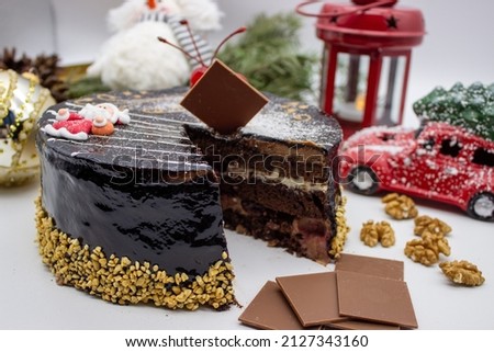 Delicious chocolate cake with Santa, with nuts and Christmas decor