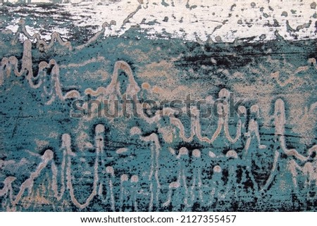 Closeup image showing the textures and colours of peeling paint on the bottom of a boat