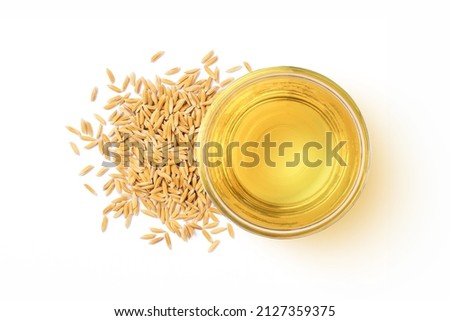 Rice bran oil extract with paddy unmilled rice isolated on white background. Top view. Flat lay. Royalty-Free Stock Photo #2127359375