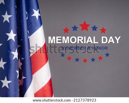 American flag with the text Memorial day, remember and honor. Studio shot over grey background. May month of annual the year