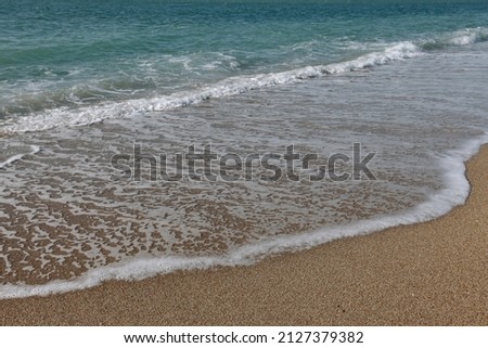 Beautiful waves roll on the shore. Marine picture, sea sandy beach.
Desktop design.