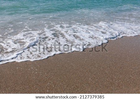 Beautiful waves roll on the shore. Marine picture, sea sandy beach.
Desktop design.