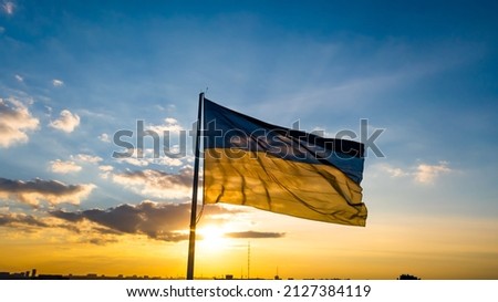 Flag of Ukraine against the backdrop of sunrise. Yellow-blue flag of independent Ukraine.
 Royalty-Free Stock Photo #2127384119