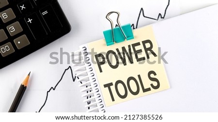 Stickers with pencils and notebook with text POWER TOOLS on the wooden background