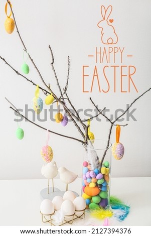 Creative greeting card for Easter celebration with eggs hanging on tree branches
