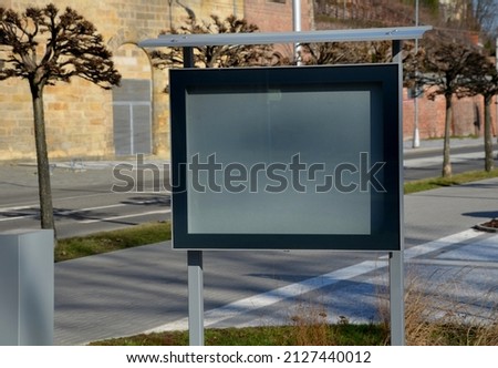 visiting rules, notice board in the town on the square, backlit glass cabinet with glass doors. gray steel with black frame. club information and documents for pedestrians to see Royalty-Free Stock Photo #2127440012