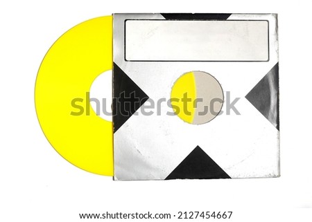 Aged black paper cover and yellow vinyl LP record isolated on white background	
