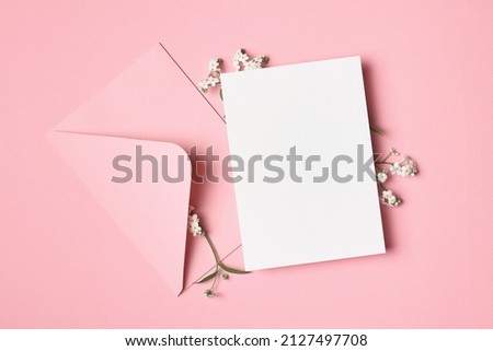Greeting or wedding invitation card mockup with envelope and flowers