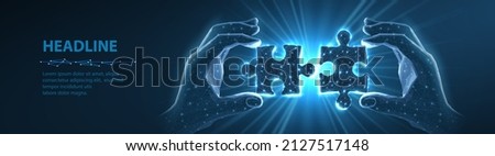Two connected puzzles and two hands. Partner collaborate, cooperate implement, digital solution, puzzle jigsaw, company merge, matching connection, business collaborate, partnership, teamwork concept. Royalty-Free Stock Photo #2127517148