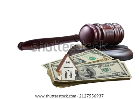 Abstract photo with wooden gavel, american dollars and abstract house isolated on black background as symbol of sale of mortgage or emergency housing at auction