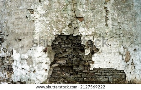 Old brick wall with destroyed plaster. Renovation of old house. Industrial style design wall background. High quality photo Royalty-Free Stock Photo #2127569222