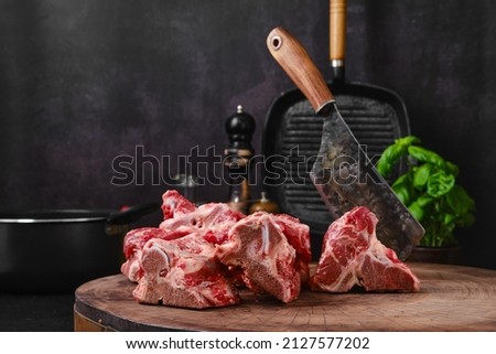 Chopped beef bones for making bouillon stock on wooden stump
