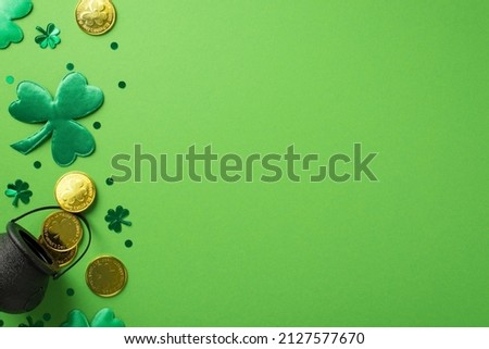 Top view photo of saint patrick's day decorations green clovers pot with gold coins and trefoil shaped confetti on isolated pastel green background with empty space