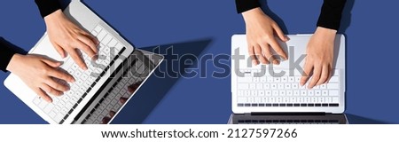 Two people working together with laptop computers