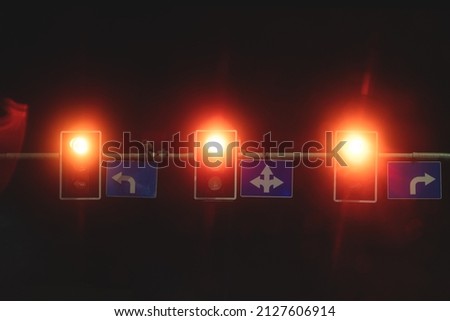 There are many traffic lights burning in different colors in the evening. City evening background