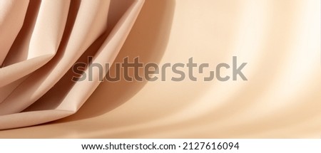 Abstract 3d studio with draping silk fabric and shadow on cream beige pastel monochrome background for cosmetic product presentation. Empty room, scene, podium or stand with copy space. Banner
