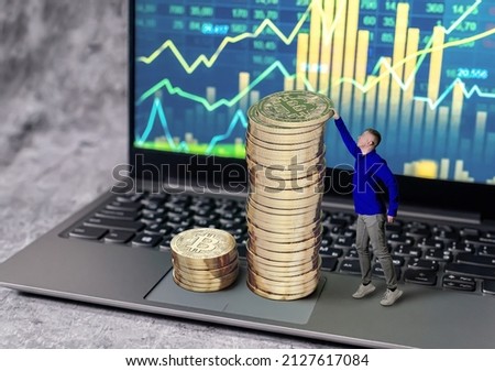 Bitcoin growth. Earnings on the growth of cryptocurrencies. A man is trying to reach for an expensive bitcoin coin. A person strives to earn on the growth of cryptocurrency. Creative photography.