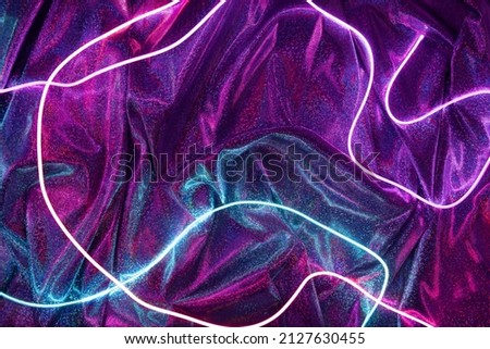Violet and blue neon lights with glitter fabric background. Abstract futuristic template.