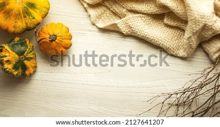 Autumn still life with pumpkins on a table with free space for your text, top view. Visual picture.