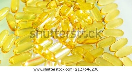 Omega 3 supplement many fish oil capsules. Selective focus. medicine.