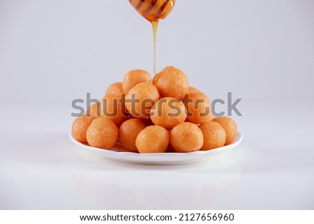 Luqaimat with honey oriental food Royalty-Free Stock Photo #2127656960